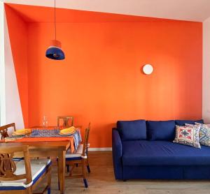 a living room with a blue couch and a table at Casa Giù in Cecina
