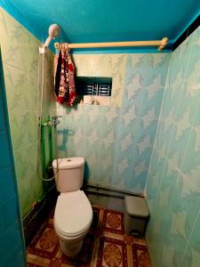 a bathroom with a toilet and a blue wall at Maison d'hôte Riad Todra in Tinerhir +56 photos