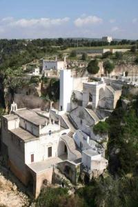 a large white building sitting on top of a hill at La Chicca nel Centro in Massafra