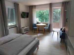 a bedroom with a bed and a table and chairs at Claar Ferienwohnung Lindau Bodensee in Lindau