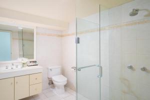 a bathroom with a toilet and a glass shower at Sheraton Surabaya Hotel & Towers in Surabaya