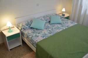 En eller flere senge i et værelse på Appartamenti Villa Frediana