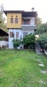 a house with a lawn in front of it at Villa Christina in Vourvourou