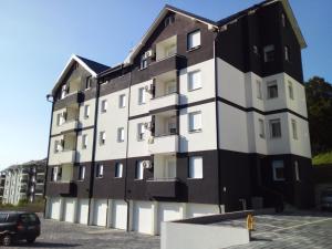 a building with a black and white facade at Apartman Nisić in Soko Banja