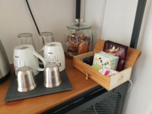 a wooden shelf with a box of items on it at L'échappée de Sologne -chez l'habitant- in Lamotte-Beuvron