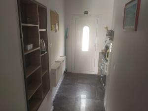 a hallway with a white door and a kitchen at Apartment Miranda in Brela +12 photos
