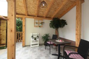 a patio with a table and chairs and a wooden ceiling at viola in Zadar