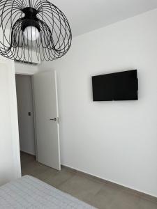 ein Zimmer mit einem Fernseher an einer weißen Wand in der Unterkunft Zahara pueblo boutique I in Zahara de los Atunes