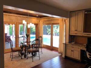 a kitchen and dining room with a table and chairs at Bright and Cheerful 4 bedroom Home with pool in Boca Raton