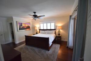 a bedroom with a bed and a ceiling fan at Bright and Cheerful 4 bedroom Home with pool in Boca Raton +40 photos