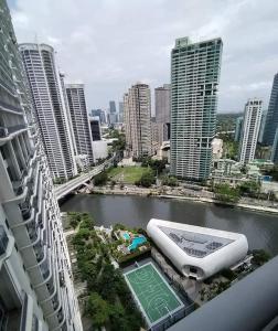 a view of a city with a river and buildings at Aveline Suites, Garden City view, 2br, amenities in Manila