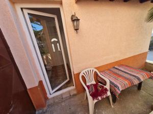 a table and a chair sitting next to a window at Ana Apartment in Negotino