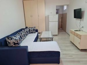 a living room with two beds and a table at Ana Apartment in Negotino