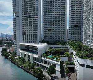 a rendering of a building next to a river with tall buildings at Aveline Suites, Garden City view, 2br, amenities in Manila