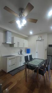 a kitchen with a dining table and a ceiling fan at Aveline Suites, Garden City view, 2br, amenities in Manila