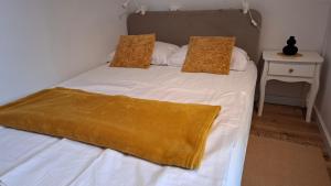 a bedroom with a bed with a yellow blanket on it at Apartma Harmonia with parking in Bled