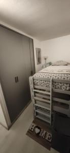 a bedroom with a bed and a sliding door at Le petit Chamois in Saint-Gervais-les-Bains