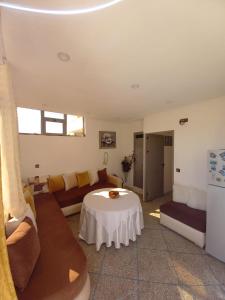 a living room with a couch and a table at Marjane house in El Jadida
