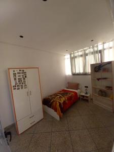 a bedroom with a bed and a mirror in it at Marjane house in El Jadida