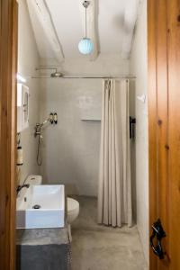 a bathroom with a sink and a toilet and a shower at Casas Velhas - Casa da Taipa in Castro Verde +16 photos