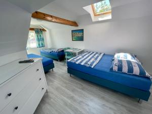 a bedroom with two beds and a dresser at Pokoje i domki letniskowe BROS in Dziwnów