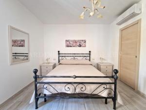 a bedroom with a bed and two night stands at Casa Gemma a 300 m dalla spiaggia Rena Bianca in Santa Teresa Gallura