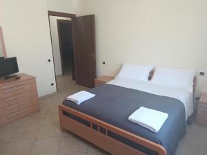 a bedroom with a large bed and a television at Casa monte cimino in Soriano nel Cimino