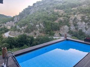 a swimming pool with a view of a mountain at Kipi Mountain Resort in Kipoi