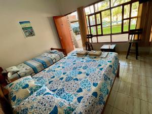 a bedroom with two beds and a window at Stone House Mancora in Máncora