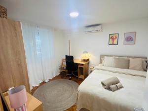 a bedroom with a bed and a desk and a chair at Julia Premium Apartment in Rijeka