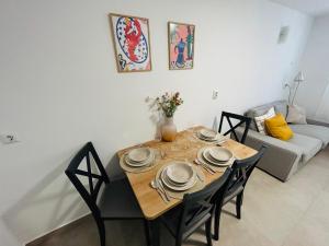 a dining room with a table and chairs and a couch at Julia Premium Apartment in Rijeka