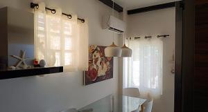a kitchen with a glass table and a window at Forever Blue in Salamina