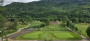 an aerial view of a golf course with mountains in the background at Apartmani Aleksandra in Kolašin