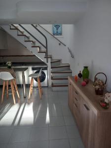 ein Wohnzimmer mit einer Treppe und einem Tisch und Stühlen in der Unterkunft Bungalows Maspalomas in Maspalomas + 3 Fotos