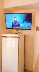 a flat screen tv on a wall above a refrigerator at Miramar con Vista al mar in Miramar