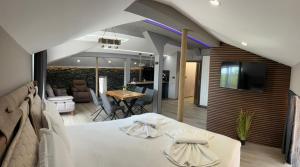 a bedroom with a bed and a living room at Guest House SG-BROTHERS in Obzor