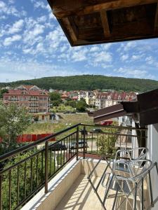 a balcony with a view of a city at Guest House SG-BROTHERS in Obzor