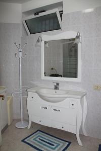 a bathroom with a white sink and a mirror at Casa Vacanze Da Nico in Matera