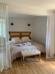 a bedroom with a bed with a bench on it at La FortBelle in Beaufort +77 photos