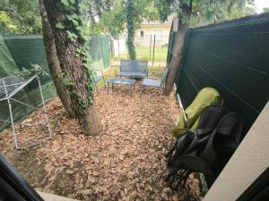 a backyard with a tree and a table and chairs at Maisonnette avec jardin in Colomiers +5 photos