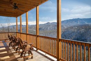 a porch with chairs and a view of mountains at The Bear and Trout by Stony Brook Cabins in Gatlinburg +31 photos