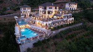 an aerial view of a mansion with a swimming pool at KERCULLA Resort in Gjirokastër