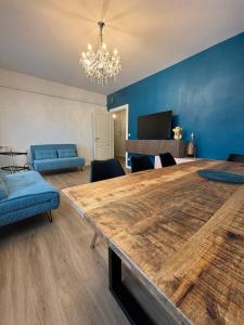 a living room with a large wooden table and blue walls at Giotto 2 Guesthouse in Maserà di Padova