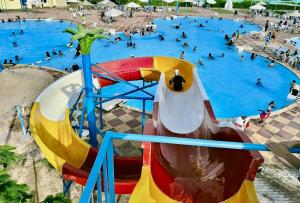 an aerial view of a water park with people in it at Sea & Pool View Deluxe Chalet - Prime Spot in Badr Resort in El Alamein
