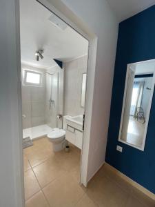 a bathroom with a toilet and a tub and a sink at Break Room in Playa Honda