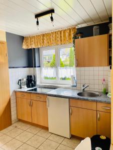 a kitchen with a sink and a window at Ferienwohnungen Klaß in Alken