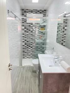 a bathroom with a sink and a toilet and a shower at Seahorse apartment El Perelló in El Perelló +10 photos