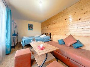 a living room with a couch and a bed at Tevra Hotel, Top of the Mountain, Camping, Nature, Ijevan, Dilijan in Ijevan
