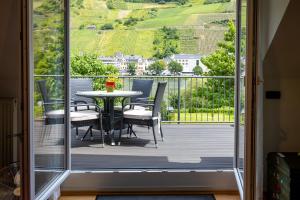 a view of a balcony with a table and chairs at Zum Blauglockenbaum in Zell an der Mosel
