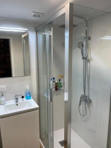 a bathroom with a shower and a sink at Casa duples junto playa Cubelas in San Ciprián +6 photos